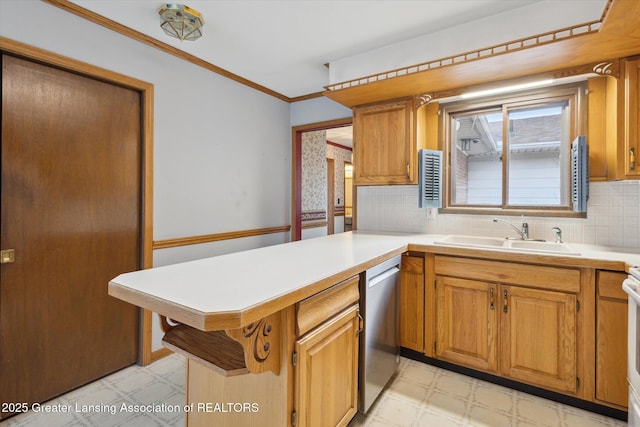 kitchen featuring a sink, dishwasher, a peninsula, and light floors