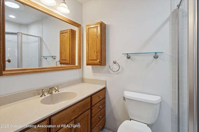 full bath with toilet, a shower stall, and vanity