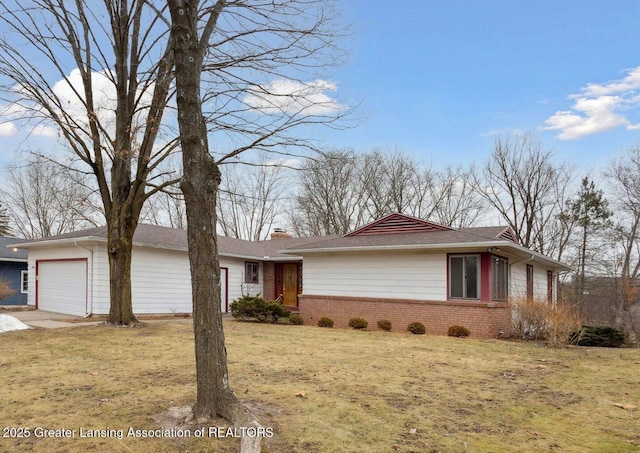 ranch-style home with an attached garage, a front yard, and brick siding