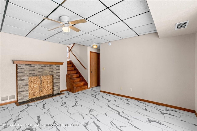 basement featuring marble finish floor, stairway, visible vents, and baseboards