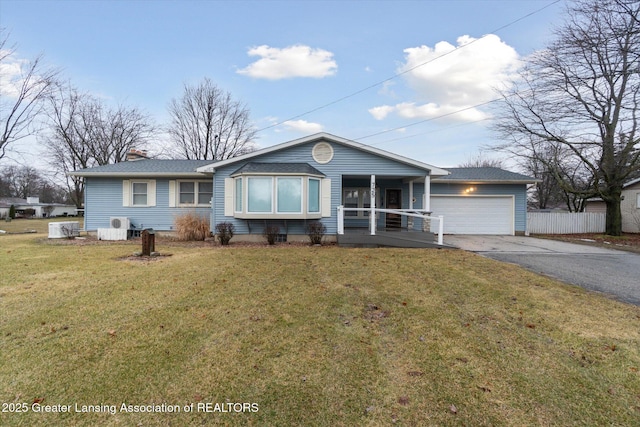 single story home with driveway, a garage, fence, a porch, and a front yard