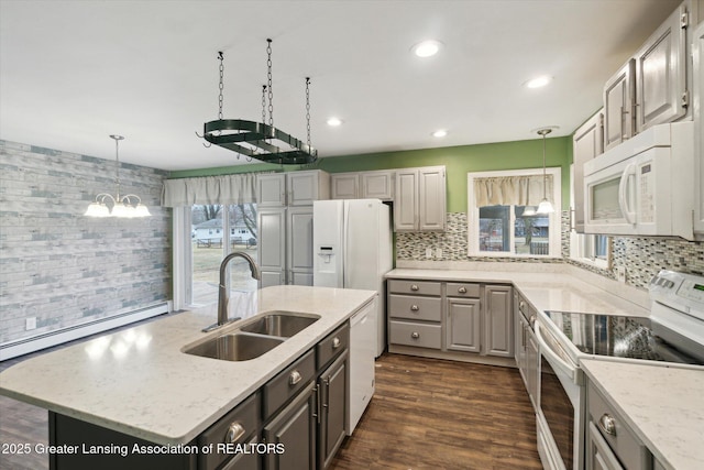 kitchen featuring white appliances, gray cabinets, a sink, and backsplash