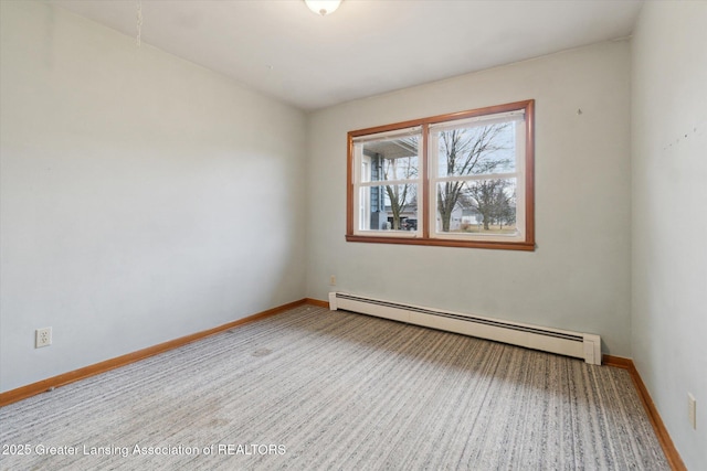 carpeted spare room featuring a baseboard radiator and baseboards