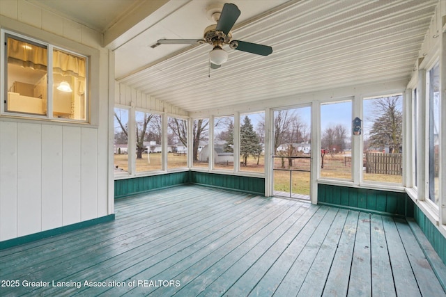 unfurnished sunroom with a ceiling fan