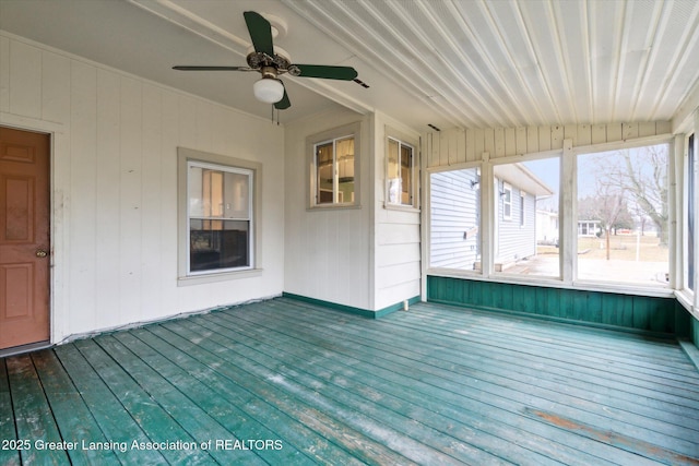 unfurnished sunroom with ceiling fan