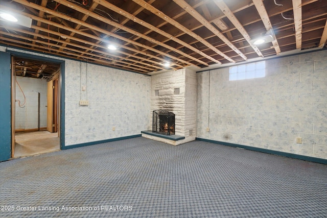 basement featuring a fireplace and carpet flooring