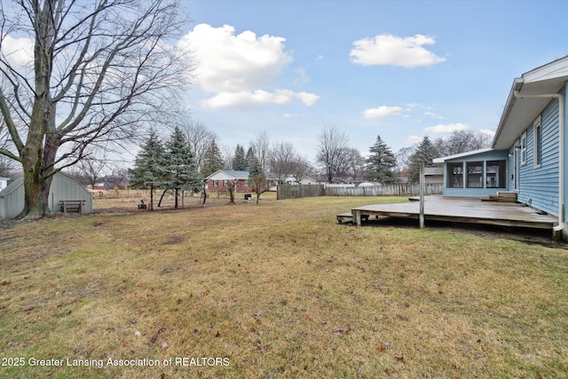 view of yard with fence and a deck