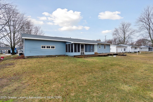 view of front of house featuring a deck, a front lawn, a chimney, and a sunroom