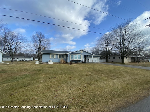 view of front of home featuring a garage, a front yard, and aphalt driveway