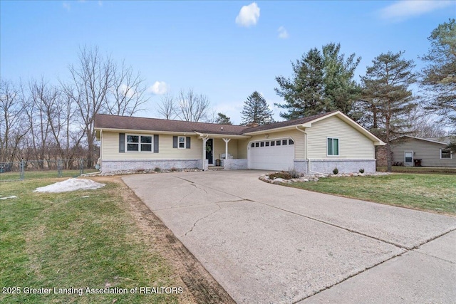 ranch-style house with a garage, concrete driveway, fence, and a front lawn