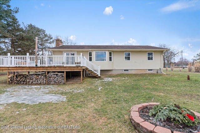 rear view of property with a yard, a chimney, a wooden deck, and stairs