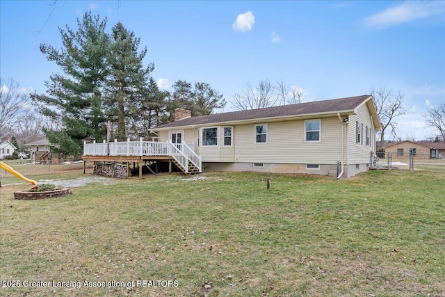 rear view of property featuring a deck, fence, a yard, a gate, and a chimney