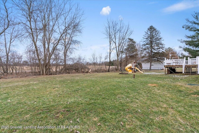 view of yard with a playground and a wooden deck