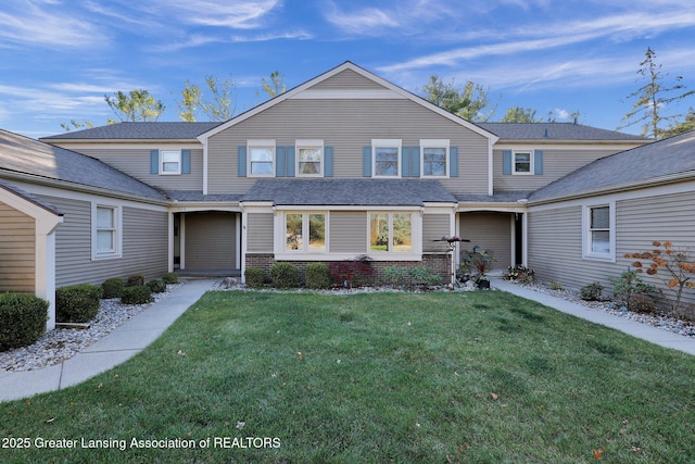 traditional home with a front yard and brick siding