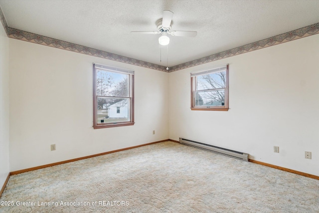 carpeted empty room with a ceiling fan, baseboards, a textured ceiling, and baseboard heating