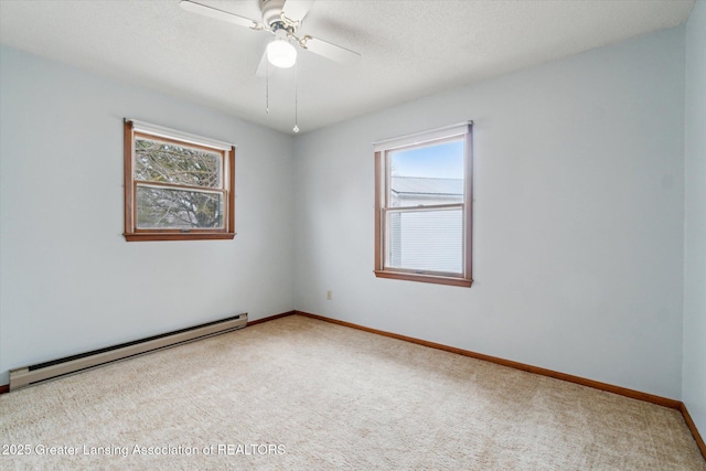 spare room featuring ceiling fan, a textured ceiling, carpet flooring, baseboards, and baseboard heating