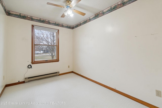 spare room with light carpet, a baseboard radiator, baseboards, and a ceiling fan