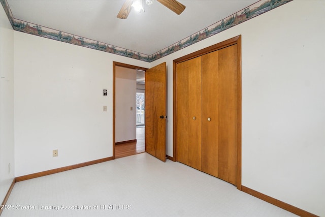 unfurnished bedroom with a closet, a ceiling fan, and baseboards