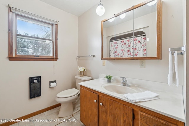 full bath featuring heating unit, toilet, vanity, tile patterned flooring, and baseboards