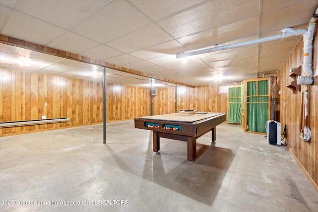 game room with concrete flooring, pool table, a paneled ceiling, and wooden walls