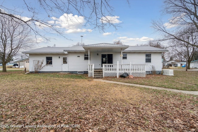 view of front of house featuring a porch, a front lawn, and metal roof