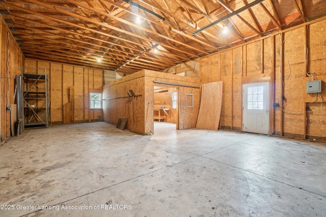 misc room with electric panel and concrete floors