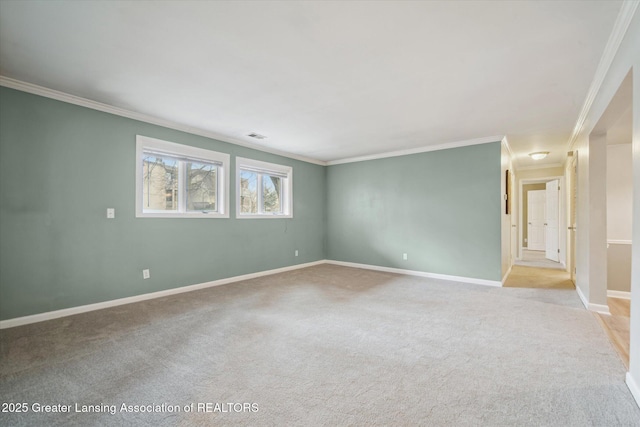 unfurnished room with ornamental molding, light carpet, visible vents, and baseboards