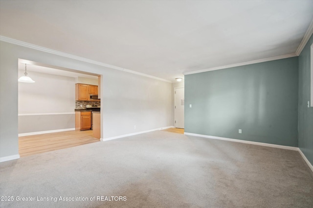 unfurnished living room featuring light carpet, baseboards, and crown molding