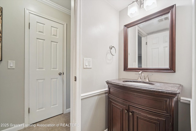 bathroom with vanity, visible vents, and baseboards