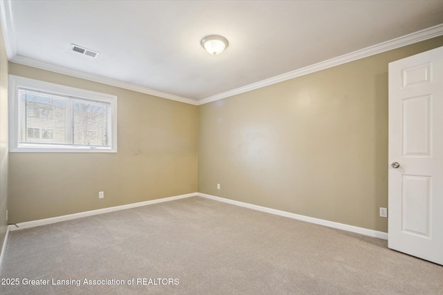 unfurnished room featuring light carpet, ornamental molding, visible vents, and baseboards