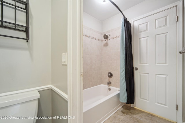 full bath featuring toilet and shower / bath combo with shower curtain