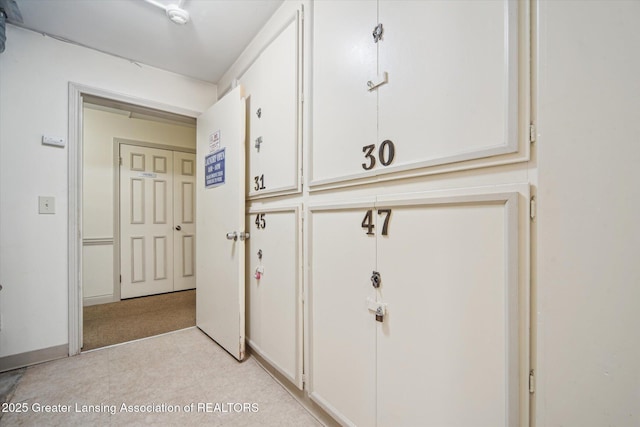 hall featuring baseboards