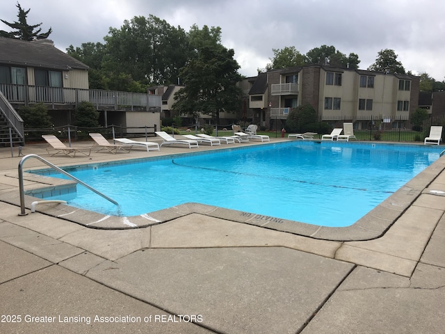 pool featuring a patio area and fence