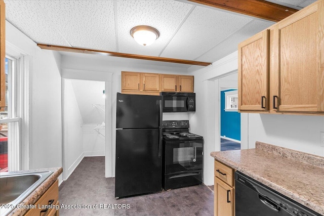 kitchen featuring black appliances, a sink, and light countertops