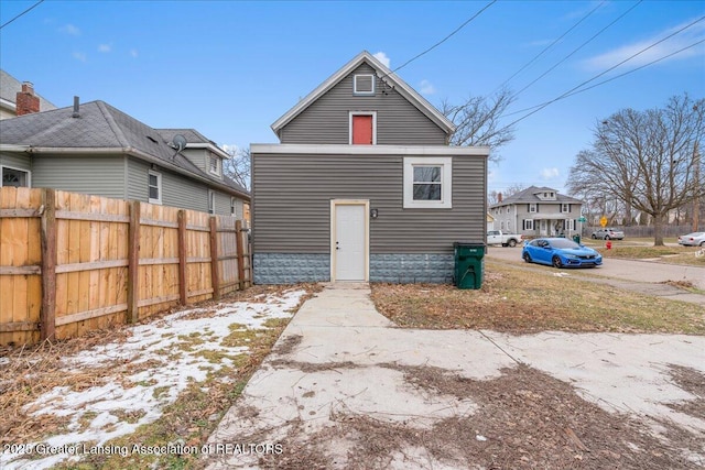 back of house with fence