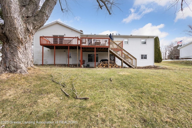 back of property featuring a lawn, stairway, and a wooden deck