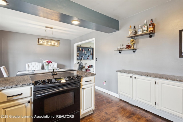 kitchen with black / electric stove, hanging light fixtures, dark wood-type flooring, white cabinetry, and baseboards