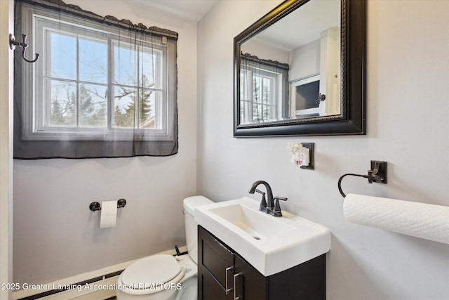 bathroom featuring a baseboard radiator, vanity, and toilet