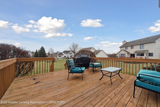 deck with a residential view and a yard