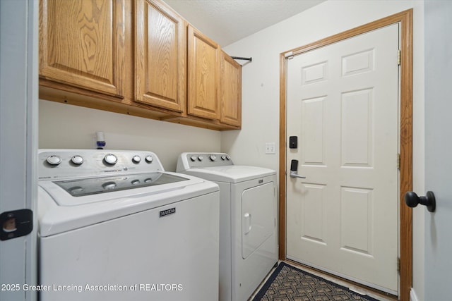 washroom with cabinet space and separate washer and dryer