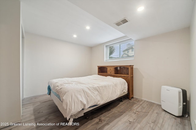 bedroom featuring recessed lighting, visible vents, and wood finished floors