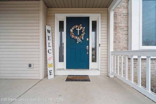 view of exterior entry with brick siding