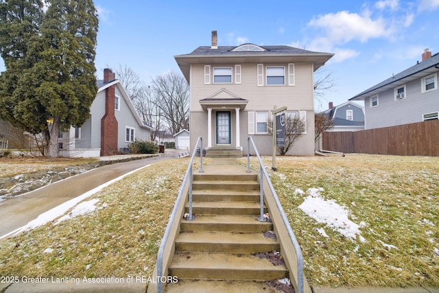 view of front of home featuring fence and an outdoor structure