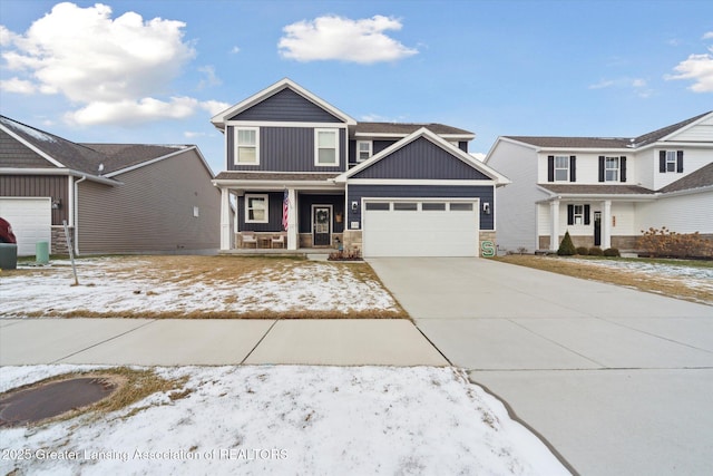 craftsman house with covered porch, driveway, board and batten siding, and an attached garage