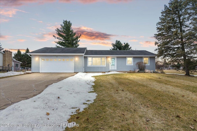 single story home featuring a garage, a yard, and driveway