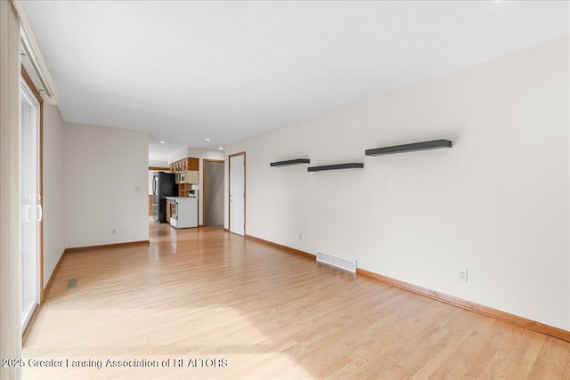 unfurnished living room featuring light wood-style flooring, recessed lighting, visible vents, and baseboards