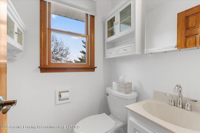 half bathroom featuring toilet and vanity