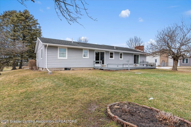 view of front of house featuring a front yard, a vegetable garden, a chimney, and a wooden deck