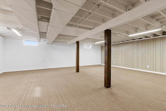 basement featuring carpet and baseboards