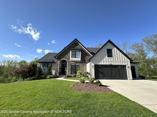 view of front of home featuring stone siding, a front lawn, board and batten siding, and concrete driveway